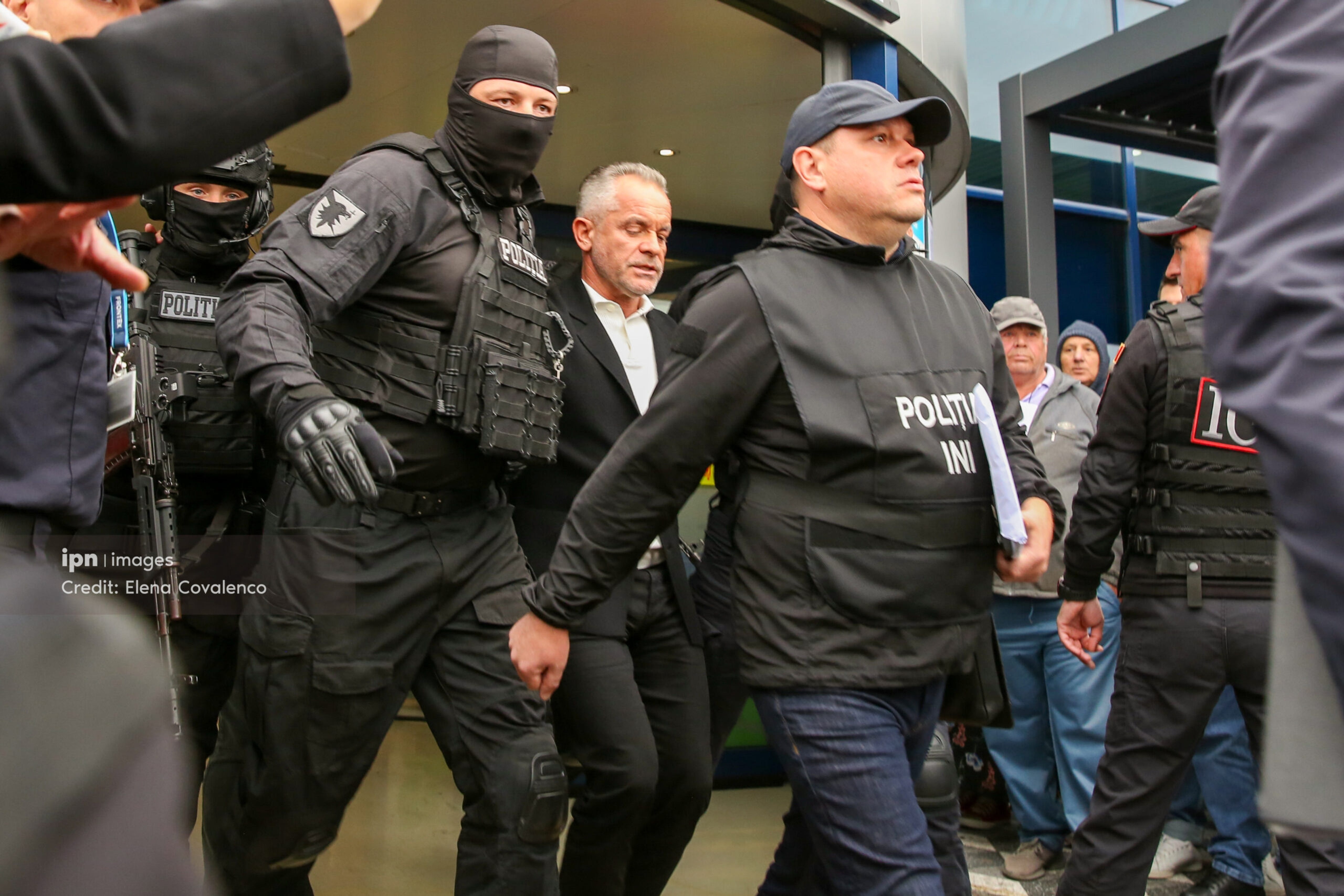 Law enforcement officers are escorting Plahotniuc out of the airport