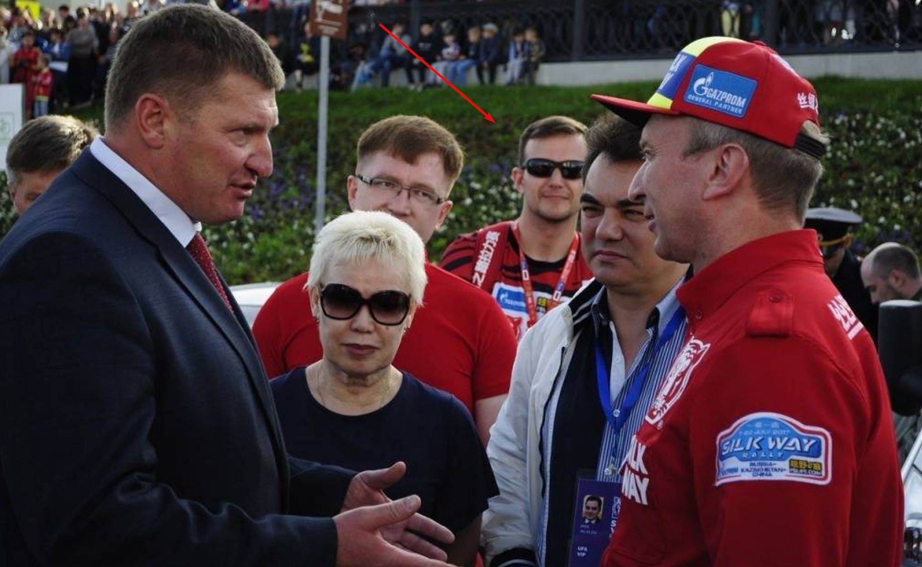 Sergey Avdeenko, a member of Unit 29155, smiling in the background and disguised as staff at the Silk Way Rally in China in 2017
