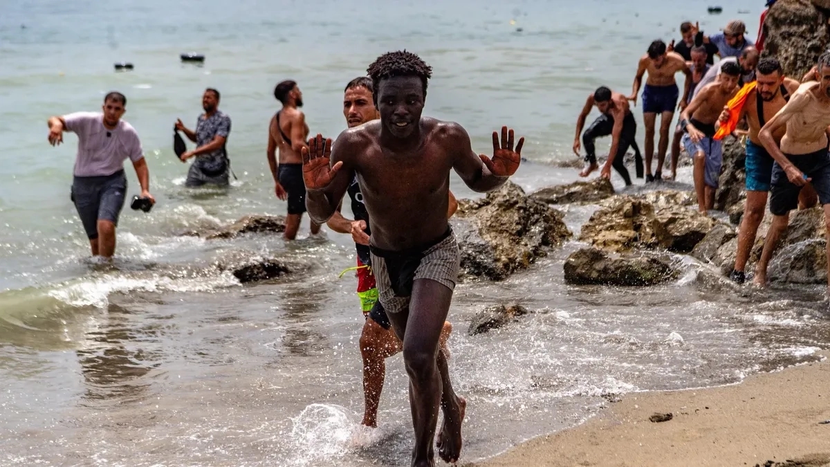 Moroccan migrants swim toward Ceuta