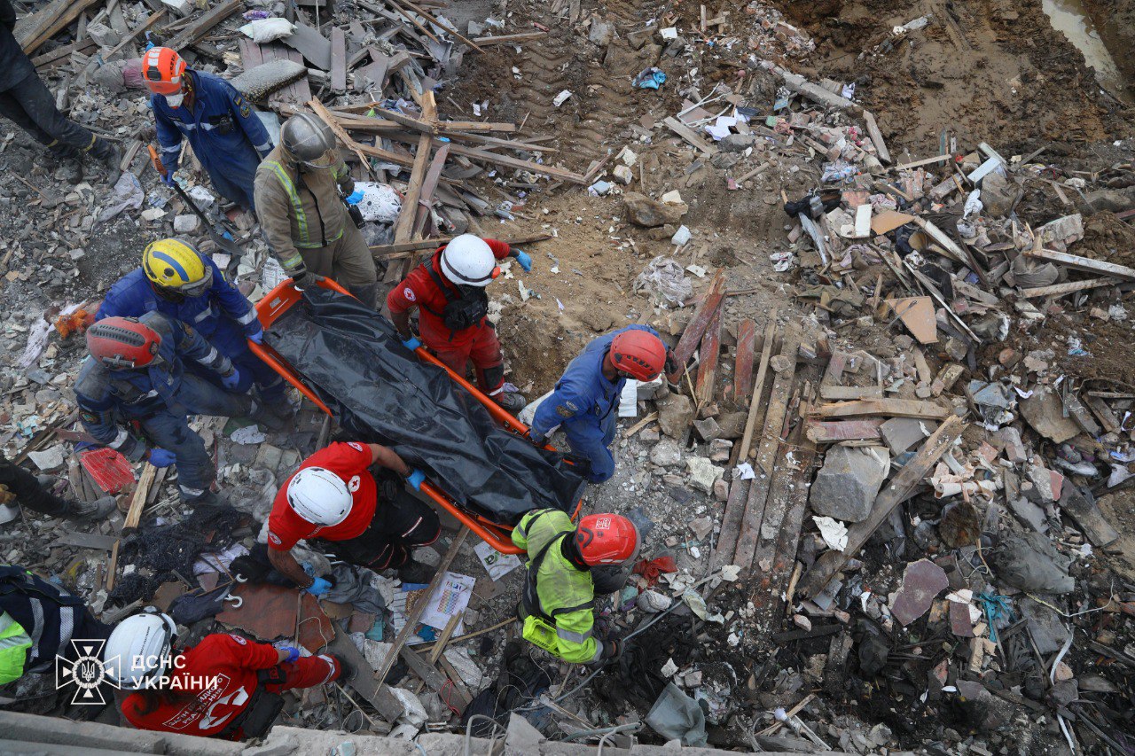 Emergency workers carrying a body pulled out from under the rubble of a building in Kyiv, Ukraine, on April 24.